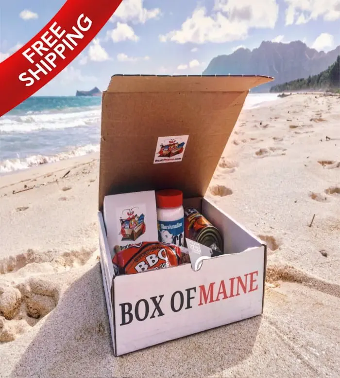 Open Box of Maine gift box on a sandy beach with Marshmallow Fluff and BBQ chips, Free Shipping banner