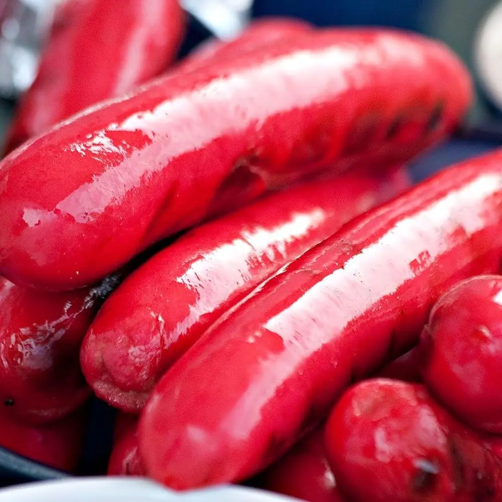 Close up of glossy bright red Maine hot dogs