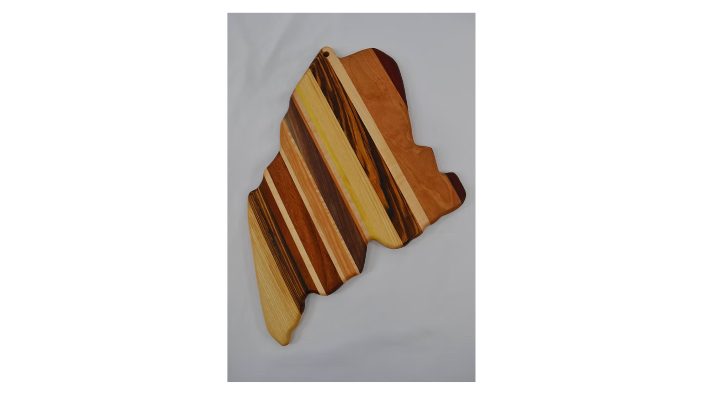 Handmade wooden cutting board crafted from natural hardwood, smooth finish, rustic kitchen accessory.