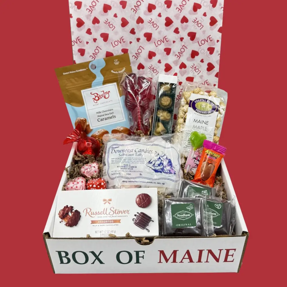 Box of Maine Valentine gift box with chocolates, caramels and candy on a heart patterned red background