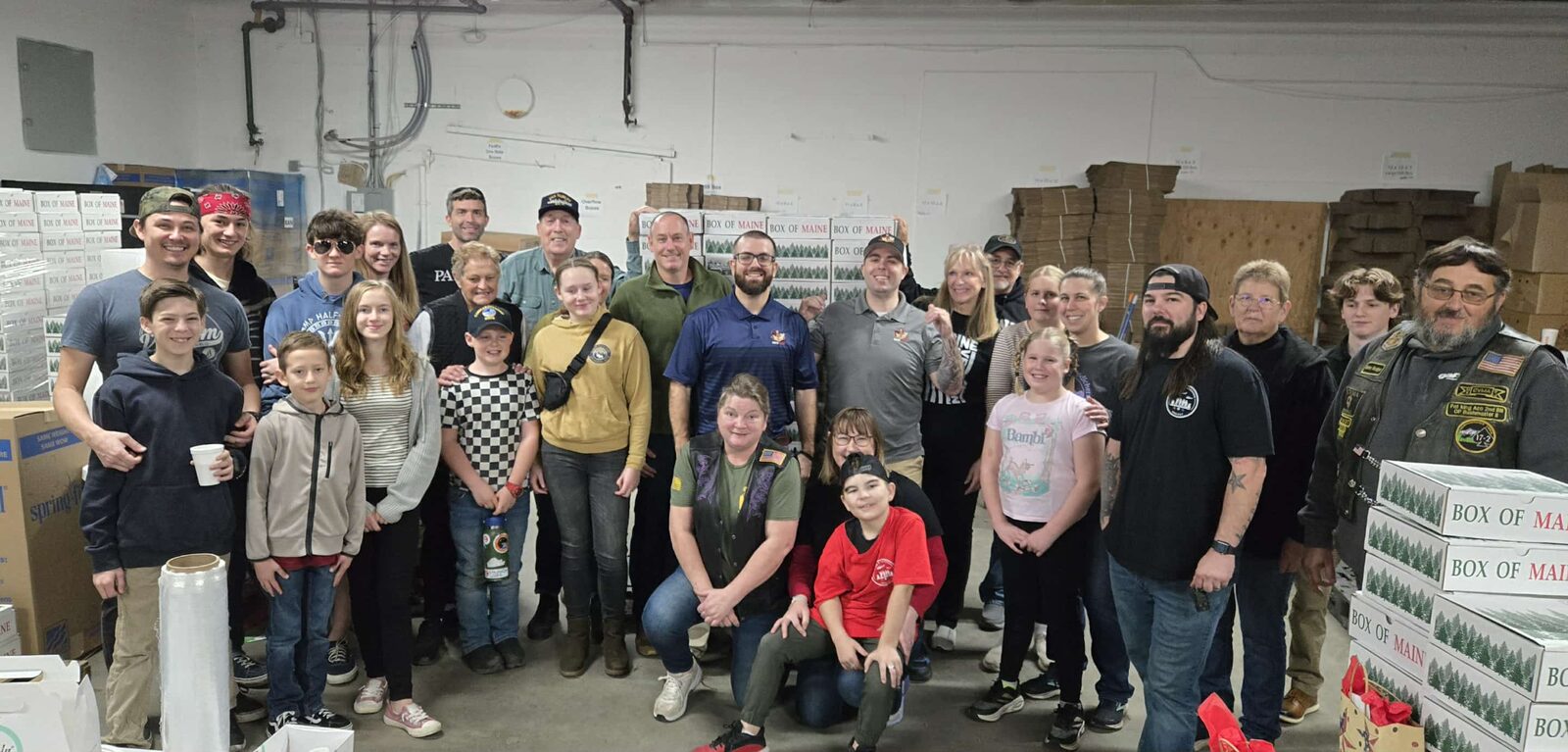 Group of volunteers and veterans at the Box of Maine care package packout